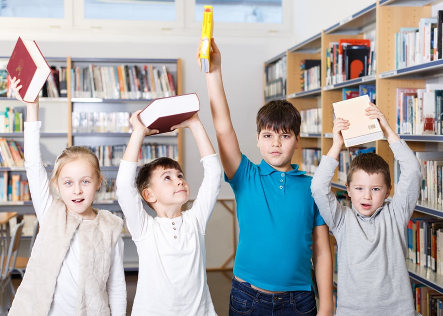 Happy children in school library